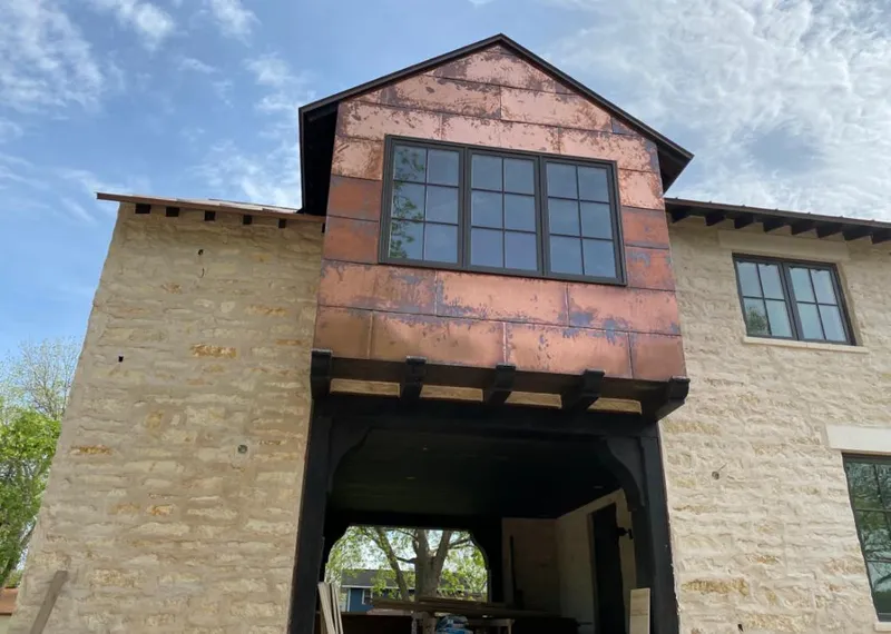 Copper metal panel facade on a stone building for Metal Roof Coating in Henryetta